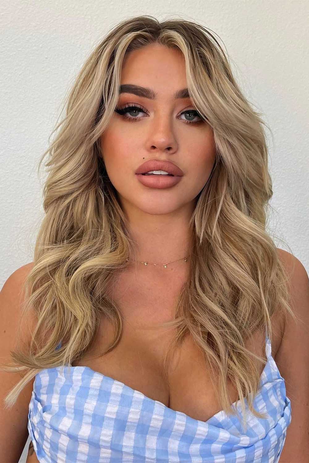 Blonde Layered Haircut with Flipped Face Framing Fringe